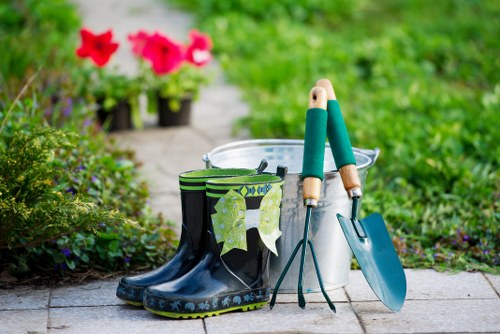 Professional gardener clearing a lush garden in Pinner